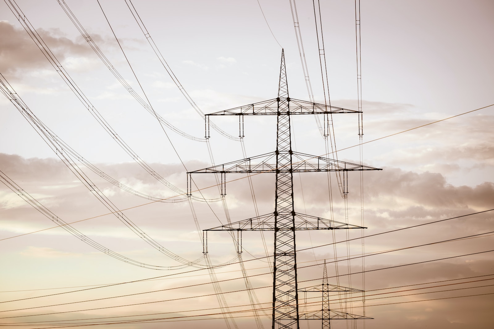 a tall tower with lots of power lines above it